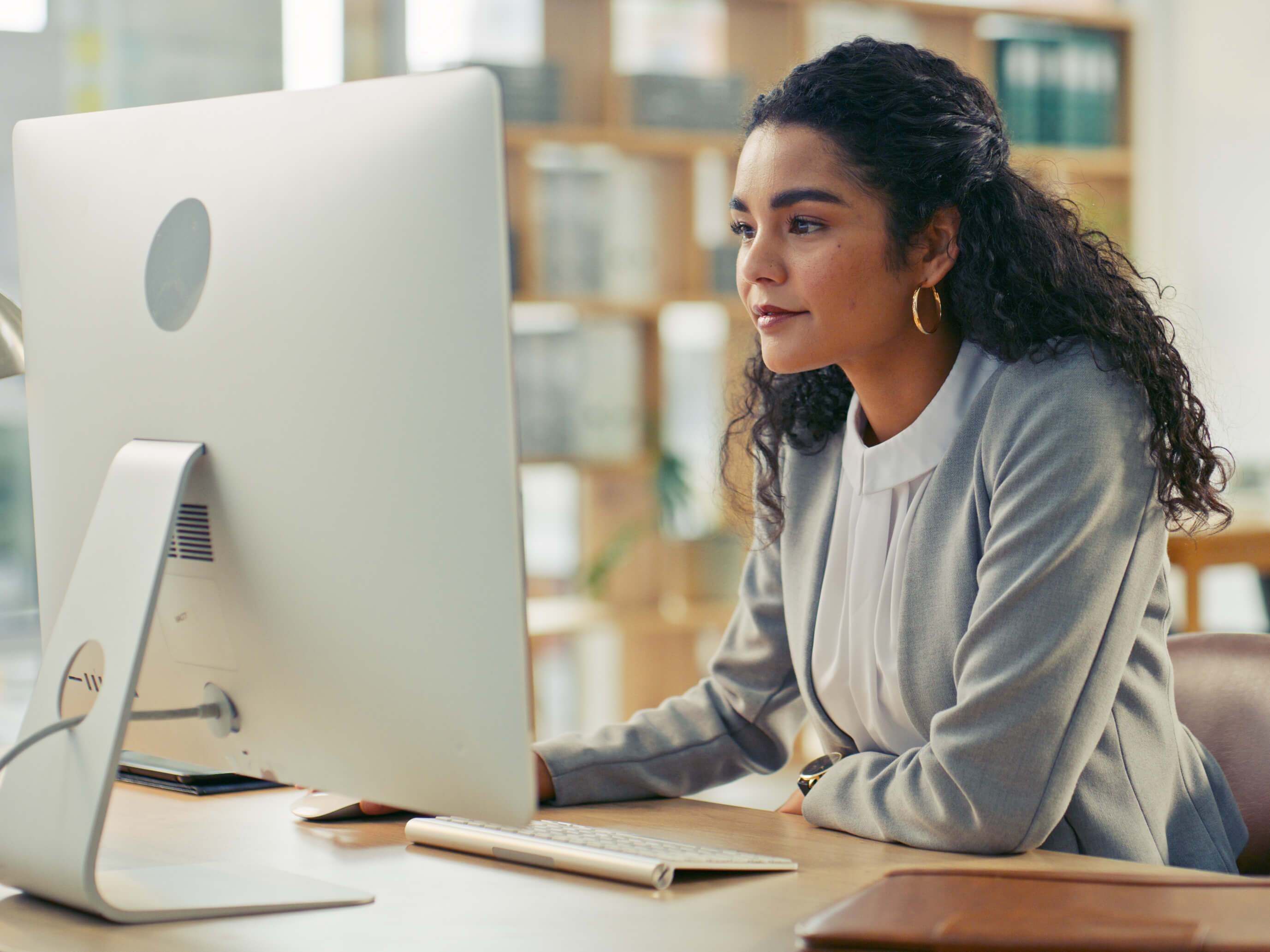A young professional woman working at her computer in the office 
