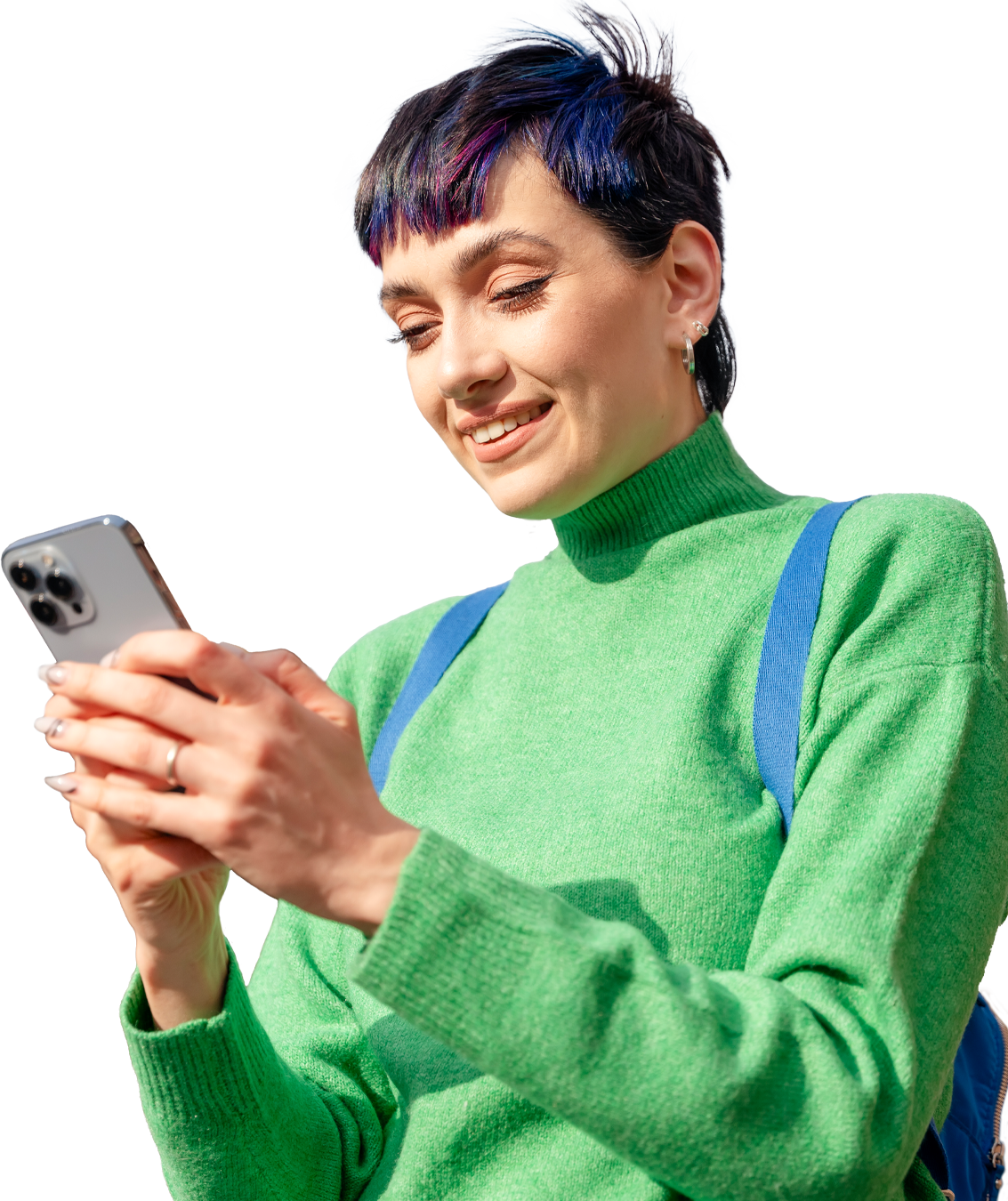 Woman in a green jumper looking at her mobile phone and smiling