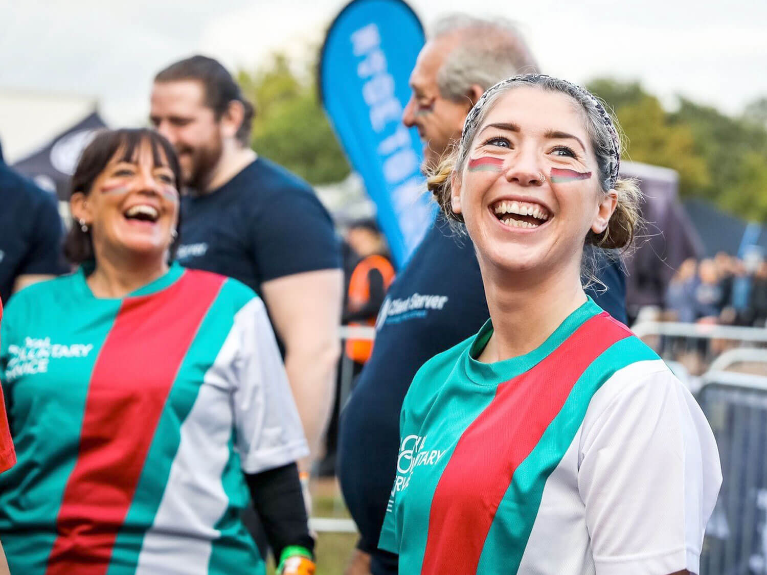 Royal Voluntary Service volunteer smiling at a Tough Mudder event